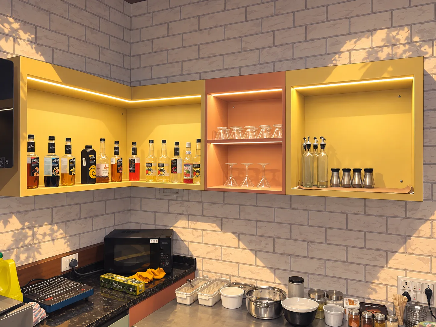 Glowing mustard and terracotta shelves of syrups and glasses